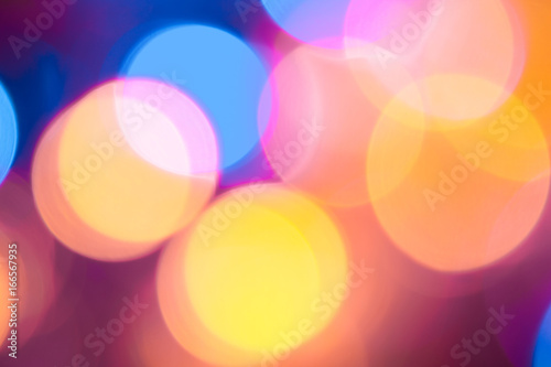 Abstract teal and orange defocused led light with black background.