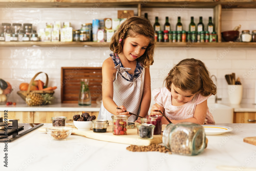 Fototapeta premium Little sisters girl preparing baking cookies.