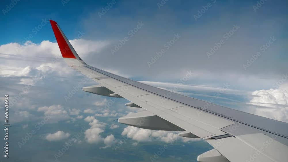 Wing of airplane on sky and cloud on moving