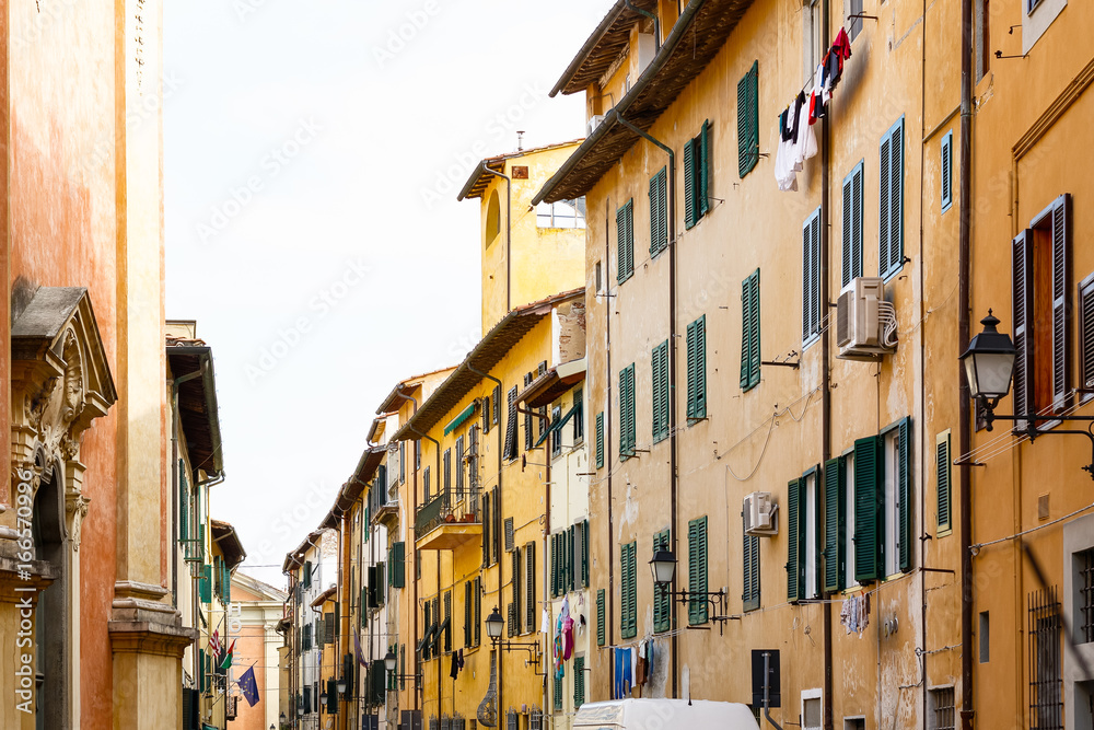Exterior of traditional Italian buildings with green shutters in Florence