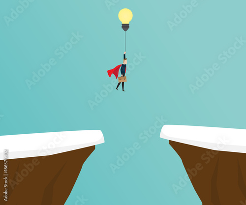 businessman flying with bulb between cliff