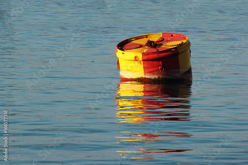 Big metal buoy in water