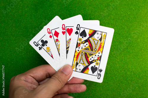 hand holding set of 4 play card in high score