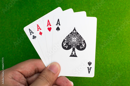 hand holding set of 4 play card in high score