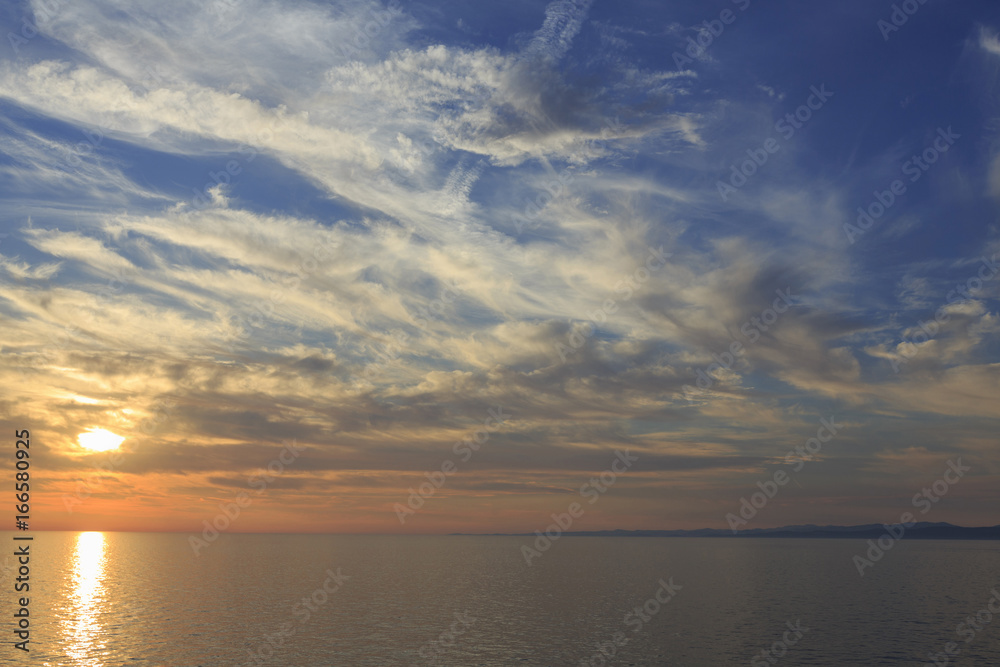 Sky and sea in the sunset, Beautiful colorful sunset with reflection, Dramatic sky background