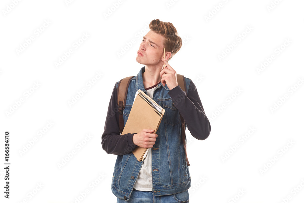 Portrait of schoolboy posing with notepads against white background Portrait of schoolboy posing with notepads against white background