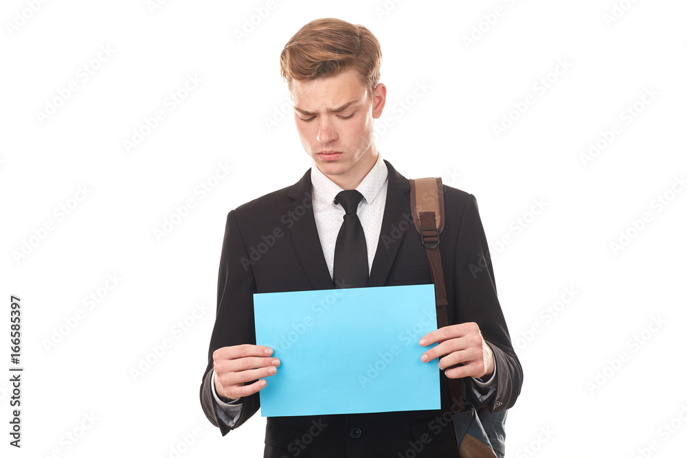 Handsome college student posing in studio with blank paper sheet Handsome college student posing in studio with blank paper sheet