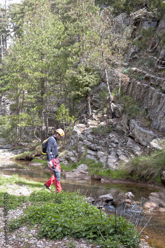 walker prepared to cross a river over the stones