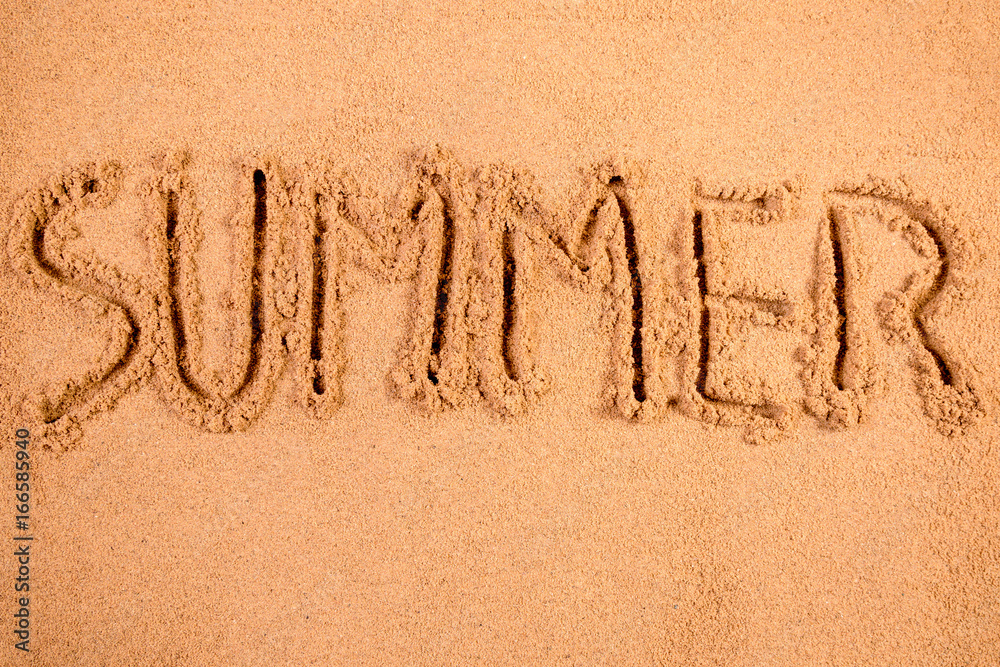 Fototapeta premium Summer written in soft wet sand on a beach
