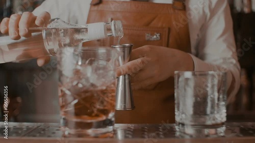 The bartender makes a cocktail