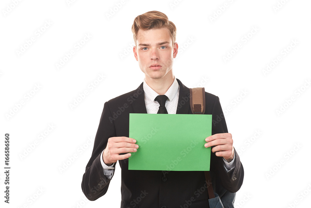 Handsome college student posing in studio with blank paper sheet Handsome college student posing in studio with blank paper sheet