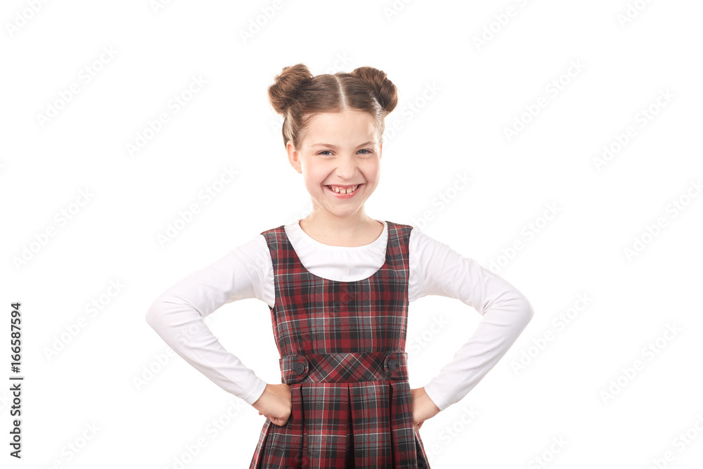 Portrait of happy girl in school uniform standing with her hands on hips against white background Portrait of happy girl in school uniform standing with her hands on hips against white background