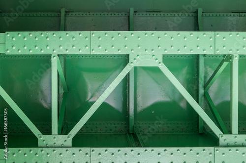 close up of green metal bridge structure for support trains