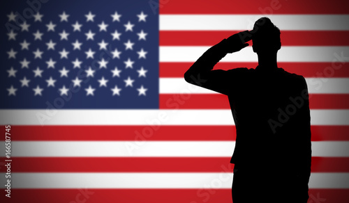фотографія Silhouette of a soldier saluting against the american flag
