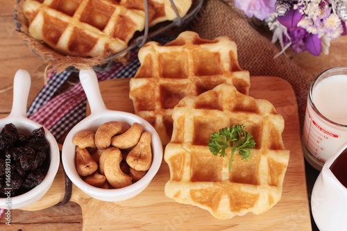 Waffles topped with honey, raisins and cashews.