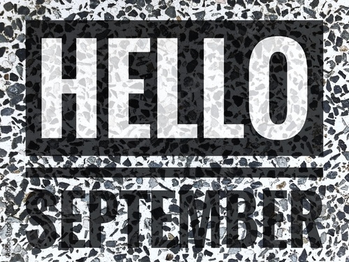 Hello September words on black and white marble table background.