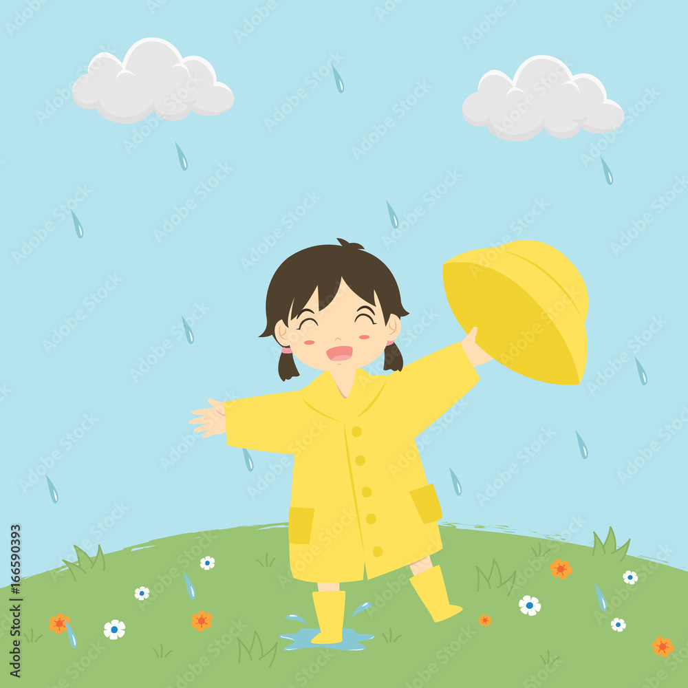 little girl in raincoat holding her rain hat happily playing under the