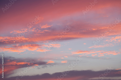 Sunset sky with orange and blue colored clouds.
