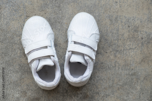 Closeup white sneakers of kid