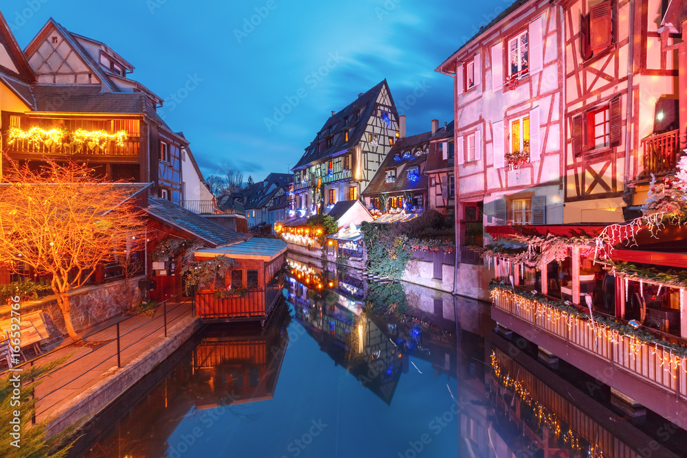 Traditional Alsatian half-timbered houses in Petite Venise or little Venice, old town of Colmar, decorated and illuminated at christmas time, Alsace, France