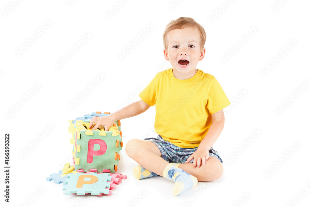 Child playing and learning letters with colorful puzzles Child playing and learning letters with colorful puzzles