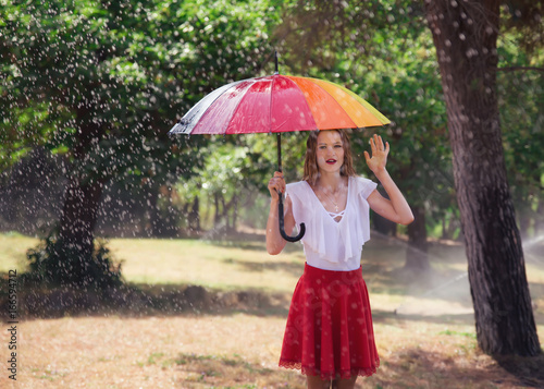 attractive young blond woman with umbrella