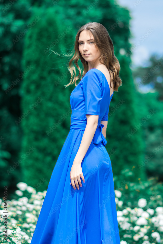 beautiful smiling girl looking at you against green background