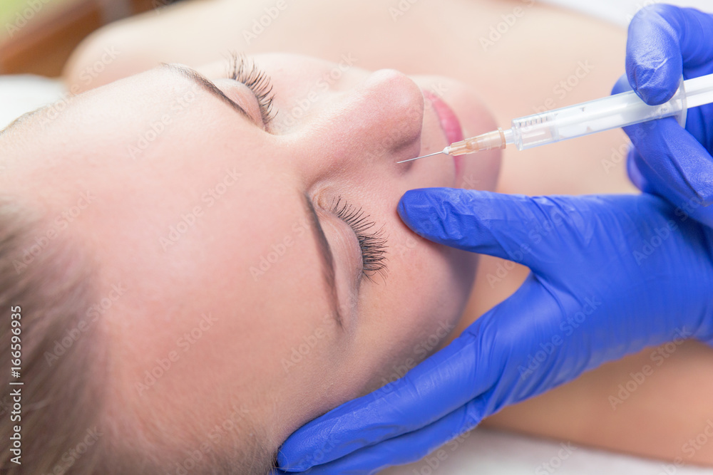 Beautiful woman gets botox injection in her face. Beautiful woman gets hyaluronic acid injection in her face. Beautiful woman gets botox injection in her face. Beautiful woman gets hyaluronic acid injection in her face.