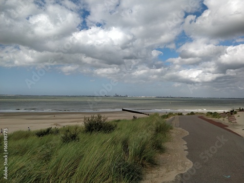 Clouds above the sea with path  dunes  sand and sea view