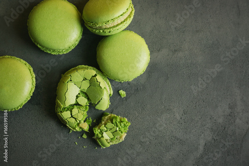 Tasty green macarons on gray background photo