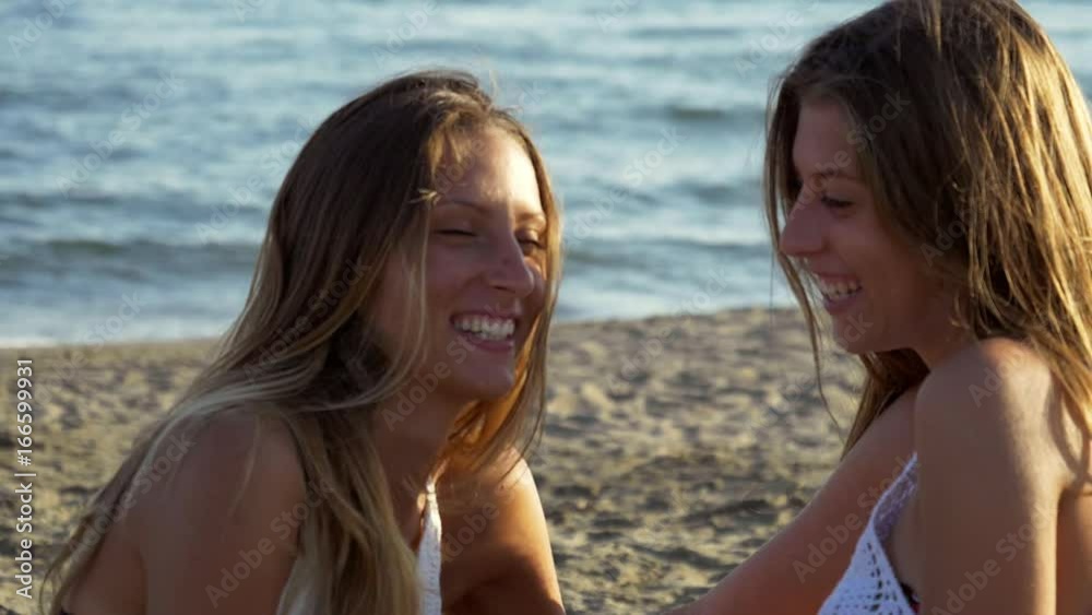 Concept of strong friendship between girls looking at each other smiling and hugging Concept of strong friendship between girls looking at each other smiling and hugging