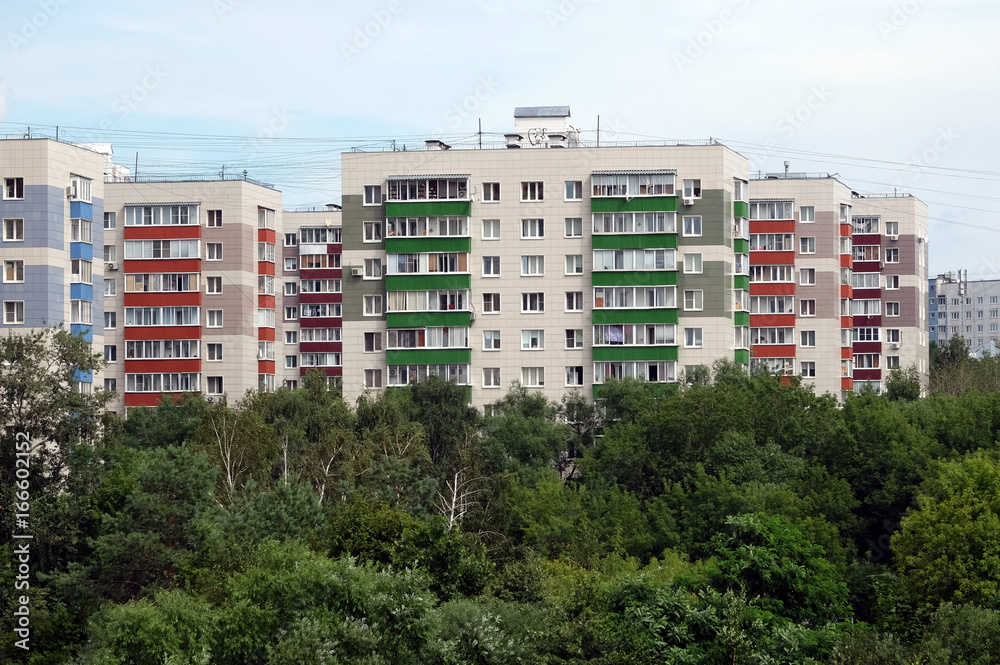 Dense urban development of apartment buildings in the green area of the city