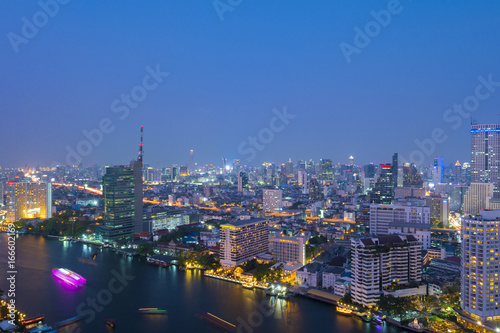 Bangkok city skyline at dusk with Chao Phraya river view.