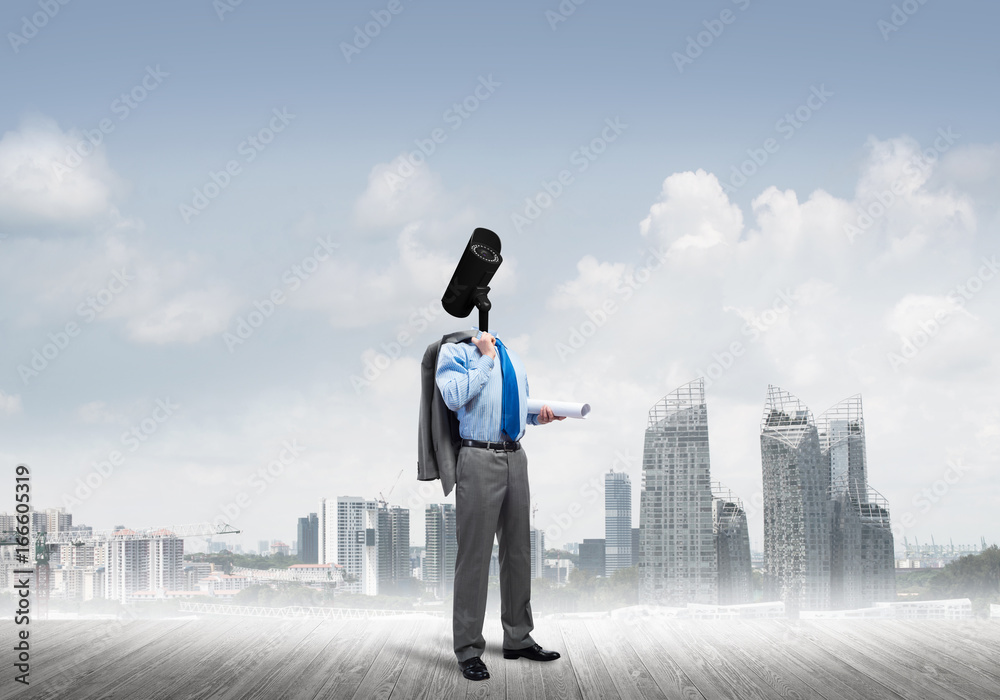 Camera headed man standing on wooden floor against modern cityscape