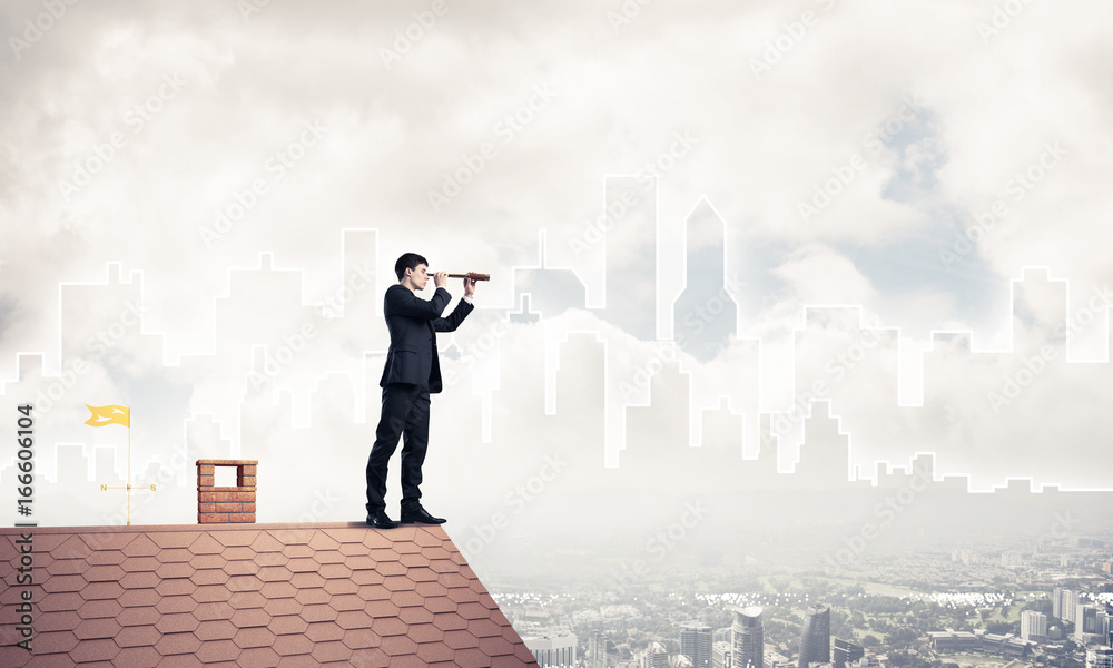 Engineer man standing on roof and looking in spyglass. Mixed med Engineer man standing on roof and looking in spyglass. Mixed med