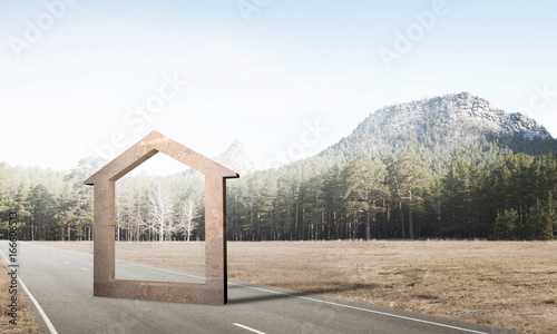 Conceptual background image of concrete home sign on asphalt road