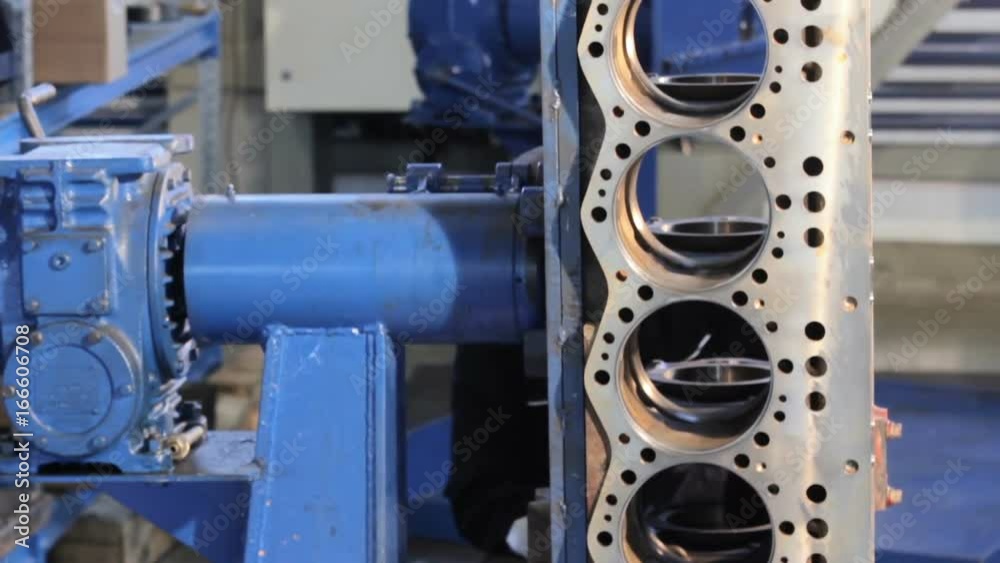 Engine assembly. Worker cleans the engine. Worker wipes the engine cylinders before assembly. Diesel engine block. Engine assembly. Worker cleans the engine. Worker wipes the engine cylinders before assembly. Diesel engine block.