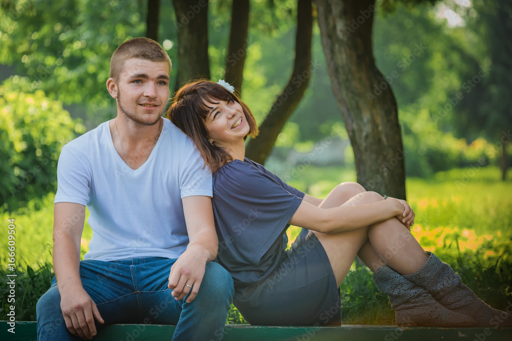 boy and girl sitting on a bench boy and girl sitting on a bench