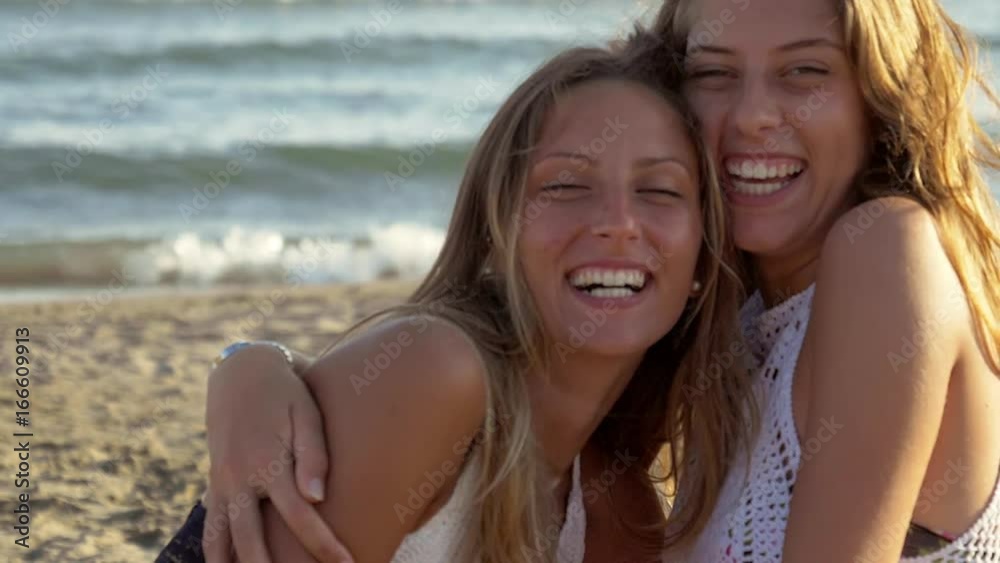 Cute girls showing happiness in vacation in summer on the beach closeup Cute girls showing happiness in vacation in summer on the beach closeup