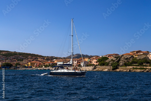 Sardinia, Italy. Yacht against the backdrop of a picturesque shore