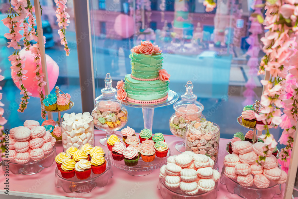Candy Bar. Delicious sweet buffet with cupcakes and wedding cake. Sweet holiday buffet with marshmallows and other desserts.