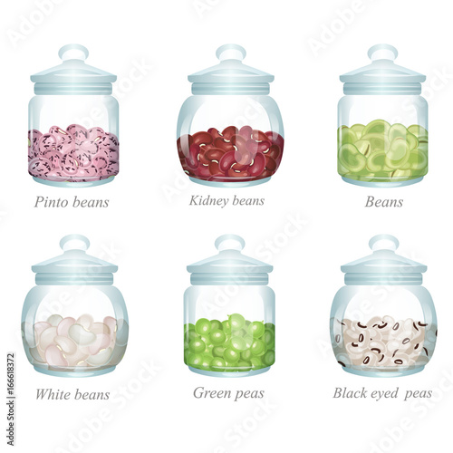 Six glass jars with beans and peas in them / There are pinto beans, kidney beans, green beans, white beans, green peas and black eyed peas in the glass jars
