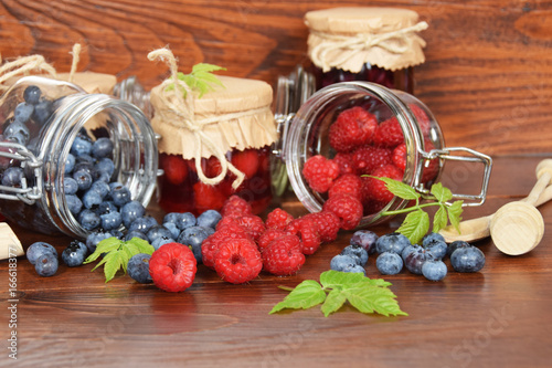 Fototapeta Naklejka Na Ścianę i Meble -  blueberries and raspberries in jars for the winter tea