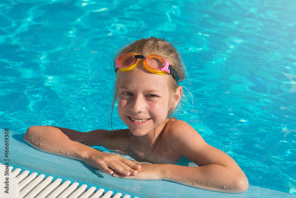 Joyful child in the pool, portrait