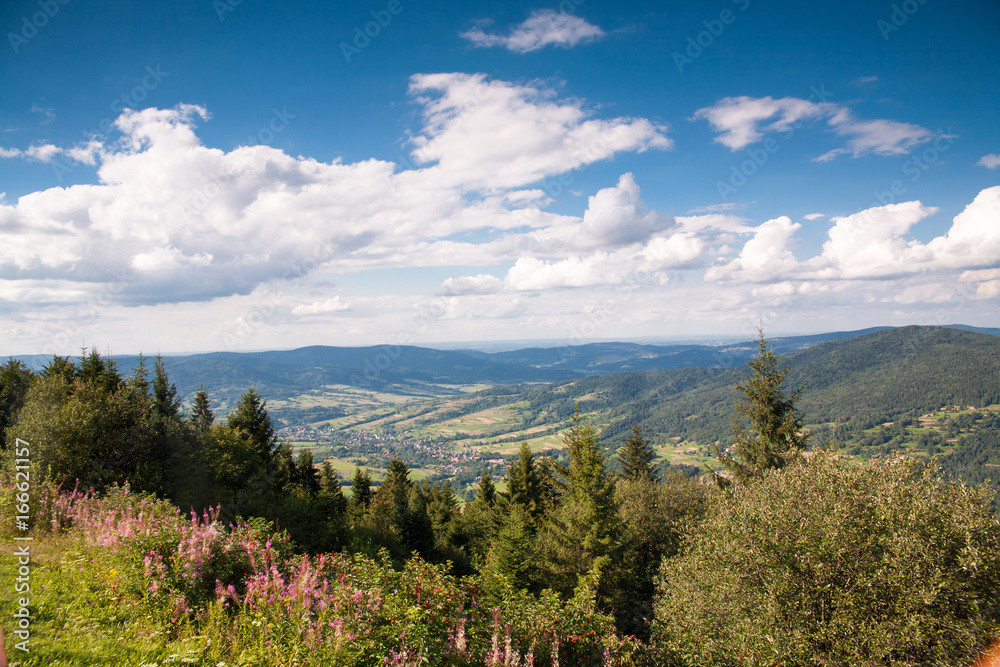 Info plate on the peak Lubon Wielki.View from the top of Lubon Wielki in Beskid Mountains. One of the lower peaks popular tourist destination with mountain chalet on top.