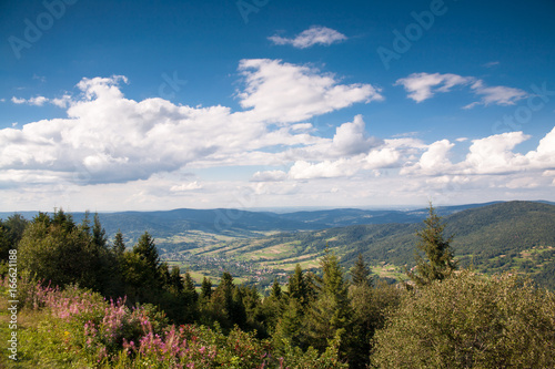Info plate on the peak Lubon Wielki.View from the top of Lubon Wielki in Beskid Mountains. One of the lower peaks popular tourist destination with mountain chalet on top.