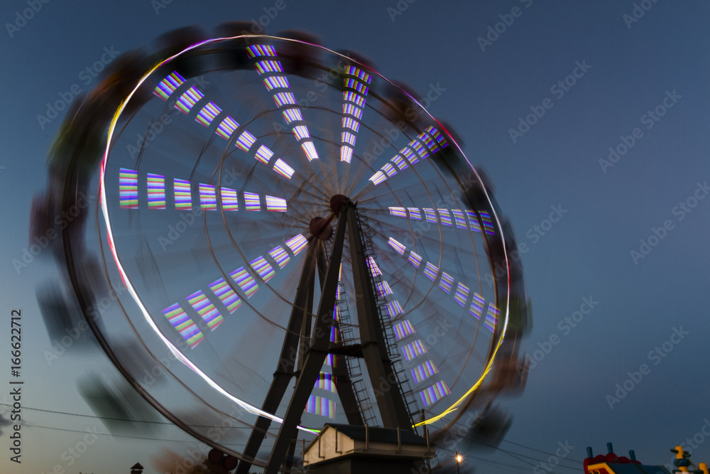 The Ferris wheel glows in the night