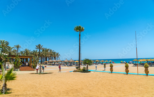 Benalmadena, Spain, june 27, 2017: Tourists lying on the Benalmadena beach near Malaga photo