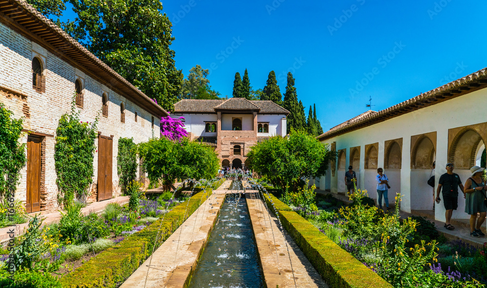 Granada, Spain, juli 1, 2017: Tourists visiting the gardens at the old city of La Alhambra