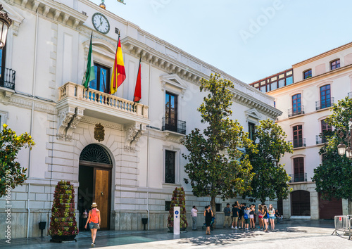 Granada, Spain, juli 1, 2017: Tourists standing in front of the tourist office on Plaza de Carmen photo